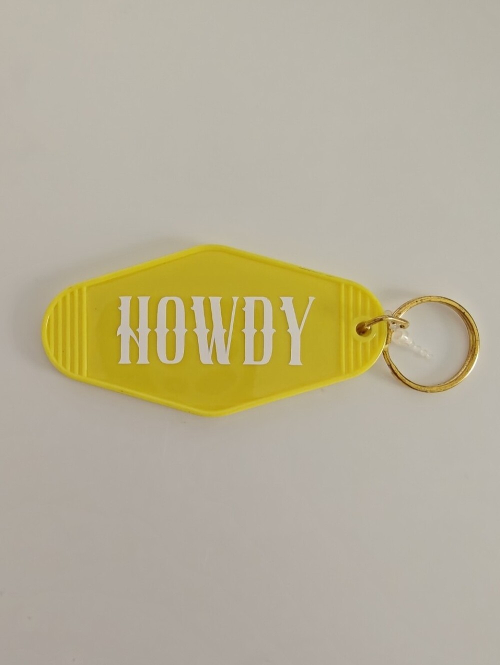 Yellow "Howdy" retro hotel/motel style plastic keychain
